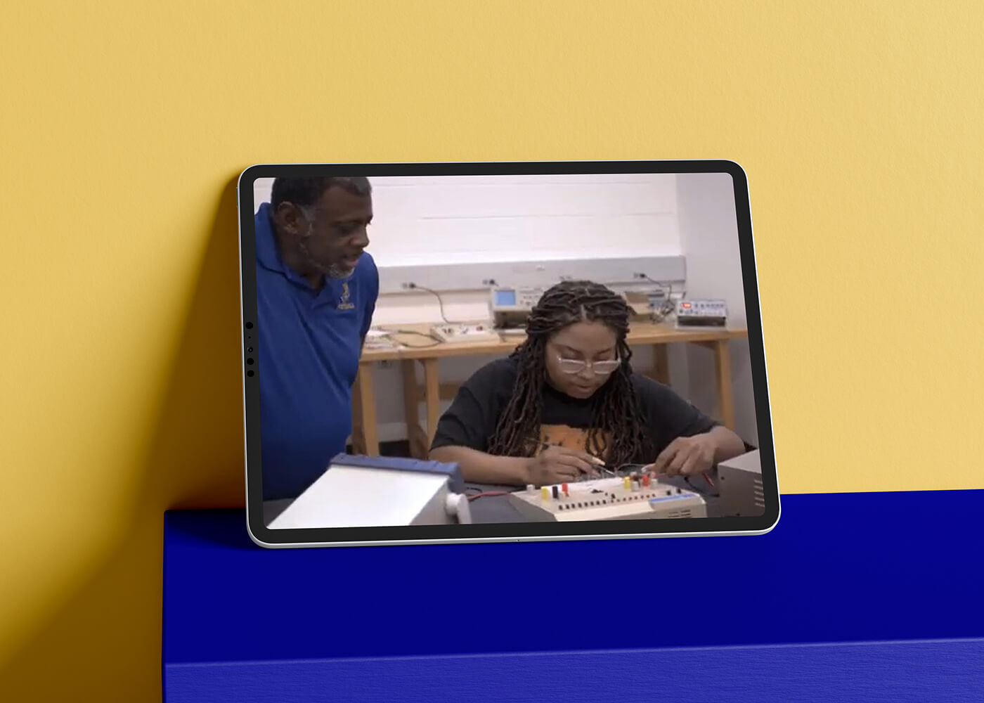 Tablet displaying an image of a Fort Valley University recruiter helping a prospective student