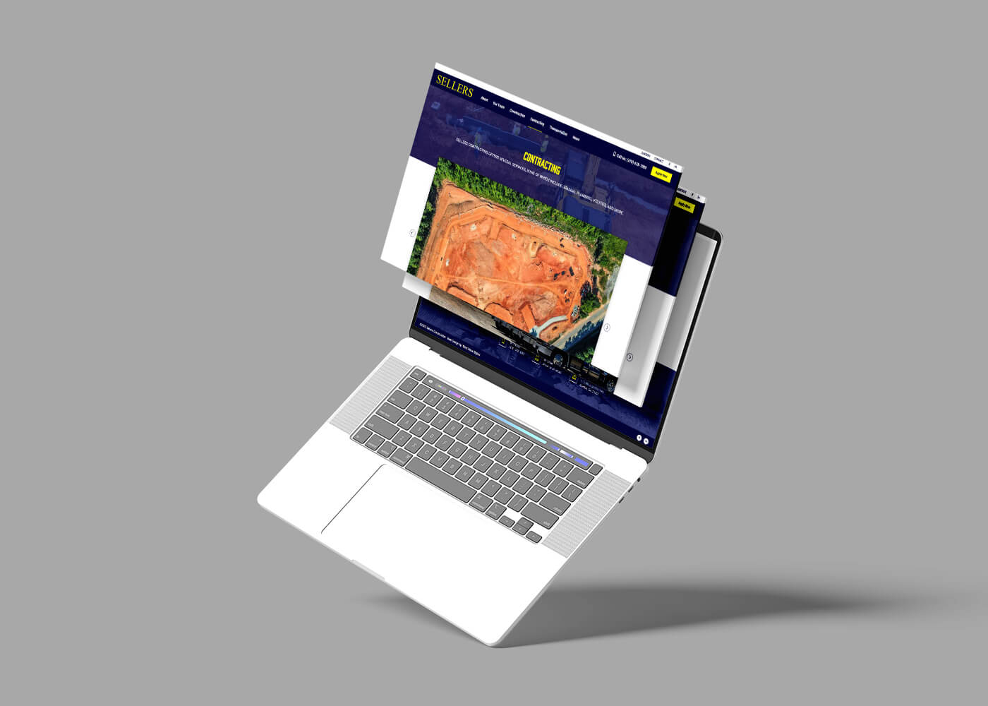 Open laptop displaying web graphics for the Sellers Construction website